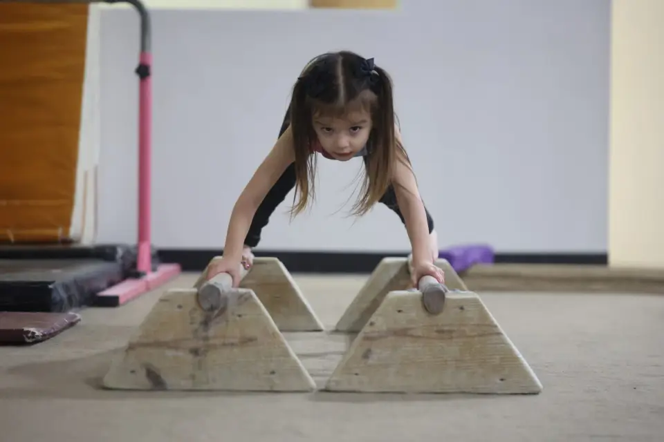 Girl practicing gymnastics on equipment